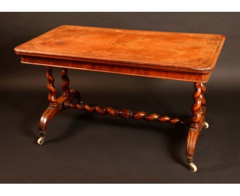 A Victorian walnut and marquetry rounded rectangular library table, moulded top with matched veneers inlaid with a broad band