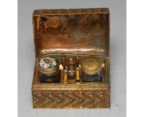 A 19th century French lady's gilt-metal rounded rectangular travelling etui, the domed hinged cover enclosing a fitted arrang