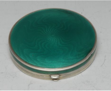 An early 20th century Continental silver and enamel circular box, hinged cover engine turned and decorated in tones of green,