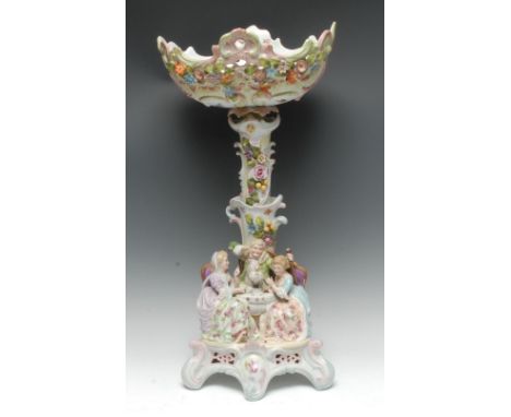 A large late 19th century Continental  figural centrepiece, the bowl and column encrusted with flowers and foliage, the base 