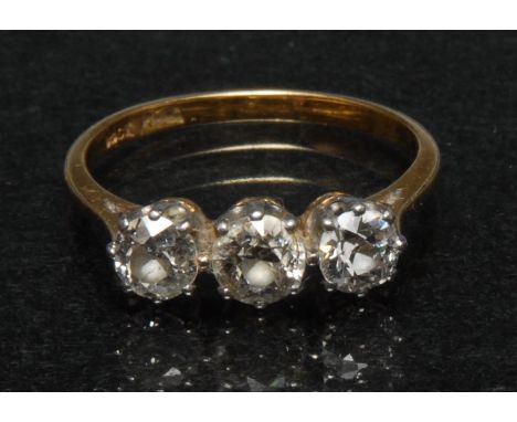 A diamond trilogy line ring, central round old brilliant cut diamond approx 0.50ct, flaked by a graduated conforming smaller 