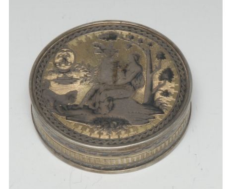 An 18th century Russian parcel-gilt silver and niello circular table snuff box, chased with and allegorical female figure bes