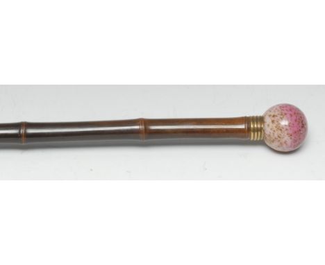 A Victorian design opalescent glass and bamboo walking stick, the glass spherical handle with iridescent metallic inclusions,