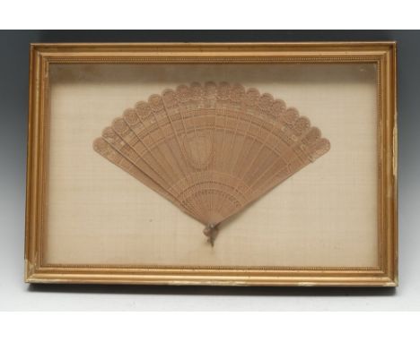 A Chinese boxwood nineteen-stick brise fan, pierced and carved with a shield shaped cartouche monogrammed for the patron, 28.