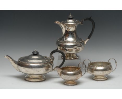 A George V silver four piece tea service, comprising teapot, water pot, milk jug and sugar basin, hinged domed covers, scroll