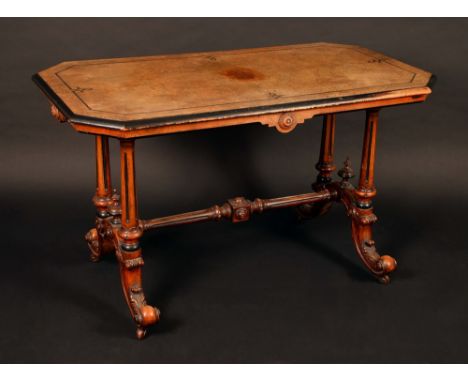 A Victorian burr walnut and marquetry canted rectangular library table, quarter veneered top above a shaped frieze, turned an