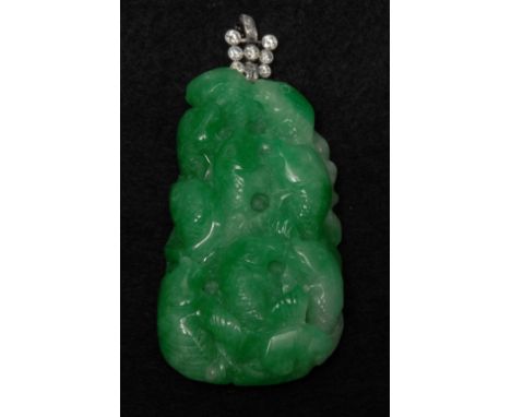 A Chinese green jade table pendant, carved as a cluster of fish swimming to front and leaves verso, suspended from a diamond 