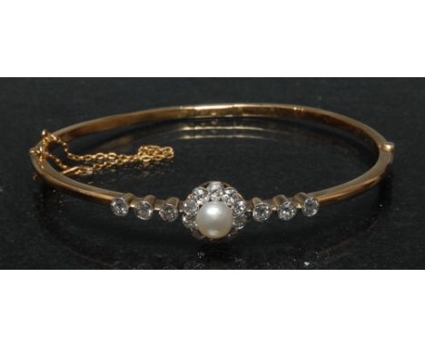 A diamond and pearl floral cluster hinge bangle, central grey white pearl, surrounded by a band of ten round old brilliant cu