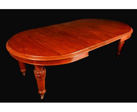 A Victorian mahogany rounded rectangular wind-out dining table, moulded top, turned acanthus carved legs, ceramic casters, tw