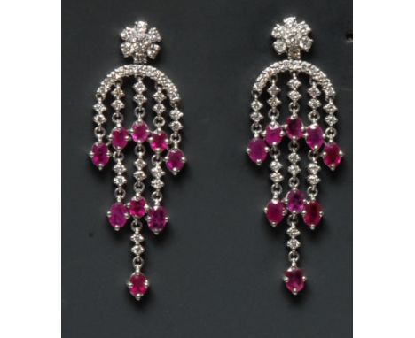 A pair of diamond and ruby Chandelier pendant earrings, each encrusted with nine oval rubies and thirty six round brilliant c