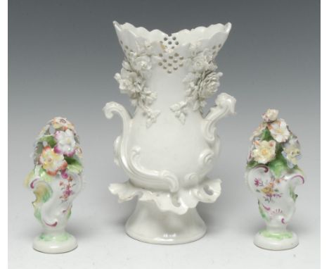 A pair of Derby Patch Mark Rococo cartouche-shaped vases, each modelled with a profusion of blossoming flowers and picked out