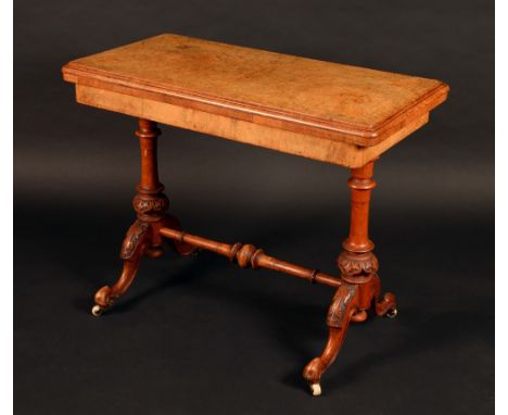 A Victorian walnut and marquetry rounded rectangular card table, folding top with matched veneers enclosing an inset baize li