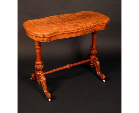 A Victorian burr walnut shaped oval card table, well figured quarter veneered folding top enclosing an inset baize lined play