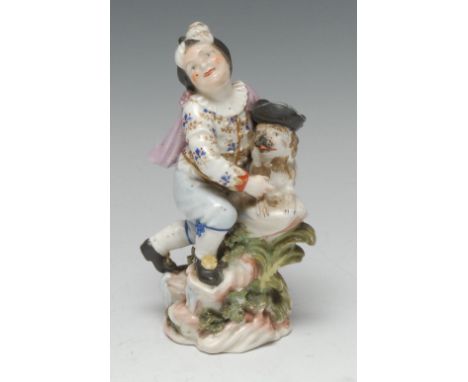 A  Derby Patch Mark figure, Boy with Macaroni Dog, he wearing a soft cap, ruffle, jacket and breeches beneath a short cape, k