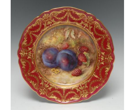 A Royal Worcester shaped circular plate, painted by Richard Seabright, with plums and raspberries, the claret border with gil