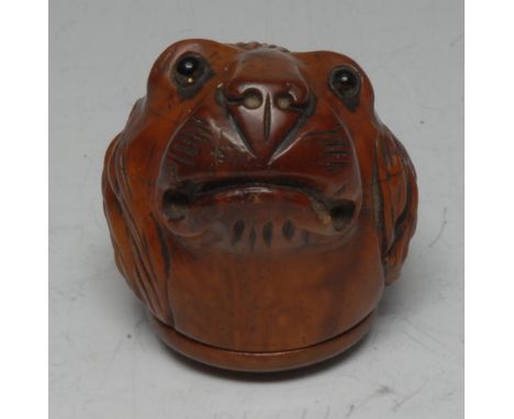 An early 19th century French coquilla nut novelty snuff box, carved as a lion's head, inset glass eyes, hinged cover, 5.5cm l
