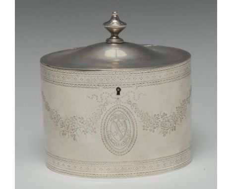 A George III silver oval tea caddy, hinged domed cover with urnular finial, bright-cut engraved with flowering swags and band