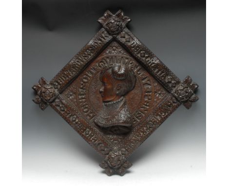 A 19th century Historicist oak lozenge shaped panel, carved in relief with a portrait of Edward VI, legend to border, Tudor r