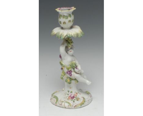 A Derby Patch Mark figural candlestick, with leafy sconce supported by a cherub encrusted in vine, fluted base in relief with