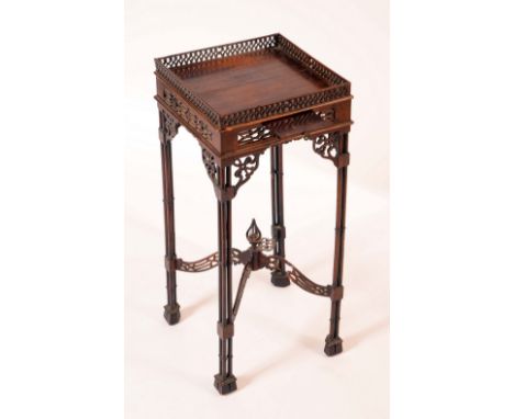 A Gothic Chippendale Revival mahogany kettle stand, square top with pierced gallery above a slide, cluster-column legs, shape