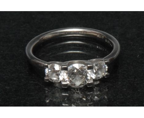 A diamond trilogy line ring,  three stepped round brilliant cut diamonds, central round brilliant cut diamond approx 0.55ct, 