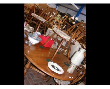 An extending Ercol table with matching six chairs