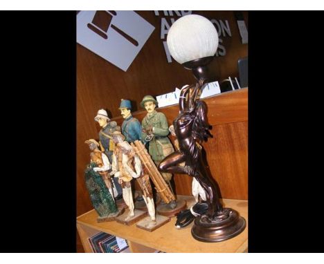 A bronzed reproduction Art Deco style lamp, together with various over sized figures 