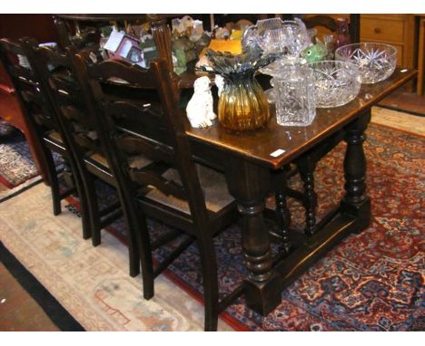 An oak refectory style dining table with a set of six ladder back chairs 