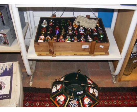 A box of vintage style glass Christmas decorations, together with a cast iron Christmas tree stand 