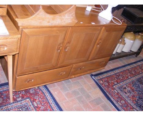 A retro Ercol 'Golden Dawn' sideboard with drawers and cupboards below 