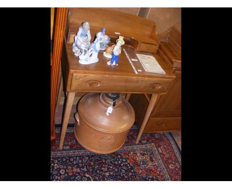 A retro Ercol 'Golden Dawn' small proportioned desk with two drawers to the upper section and a single drawer to the apron 