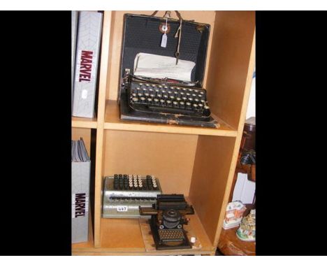 A vintage Remington compact portable typewriter and mechanical calculator 