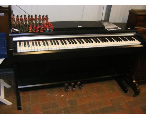 A Yamaha Arius electric piano with manual 