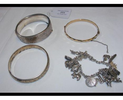 A silver bangle, charm bracelet, etc. 