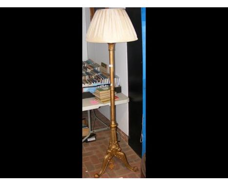 A decorative gilt standard lamp