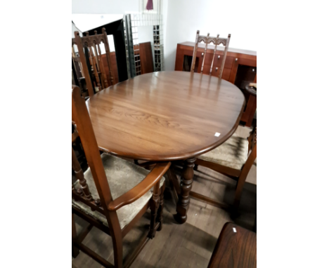 A VINTAGE ERCOL EXTENDING DINING TABLE AND FOUR CHAIRS