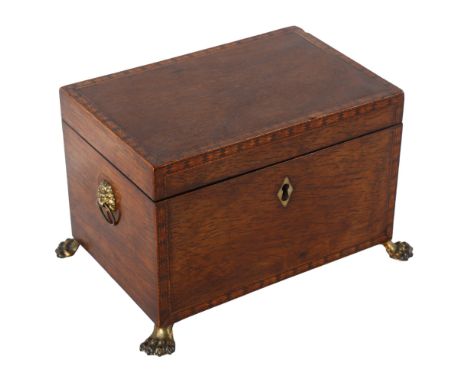 A Regency exotic wood tea caddy, possibly partridge wood, with inlaid parquetry bands, inner lids with bone handles, resting 