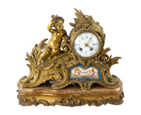 An early 19th century gilt-bronze cased mantel clock by Raingo Frere Paris, Rococo style case surmounted by a putti with a bi