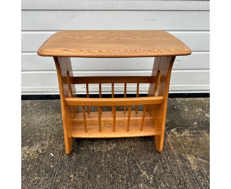 Ercol – an Ercol blonde elm “Evergreen” magazine rack. Height 49cm, width 55cm, depth 36cm.There are some very light surface 