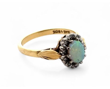 An opal and diamond cluster ring, stamped 18ct. Size L. 3.9g.