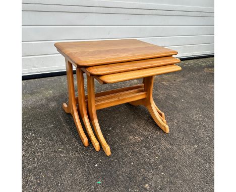 An Ercol style mid-century elm nest of tables. Height 44cm, length 58cm, depth 44cm, smallest height 40cm. (3)There are some 