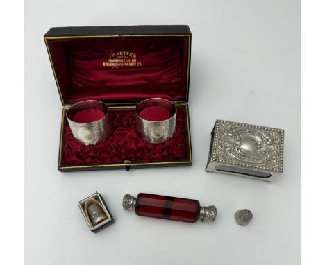 A silver matchbox holder by Levi &amp; Salaman Birmingham 1899, a boxed pair of silver napkin rings with blank cartouches, tw