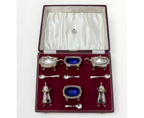 A cased Garrard &amp; Co Ltd six piece silver cruet set with blue glass liners. Birmingham 1968. 