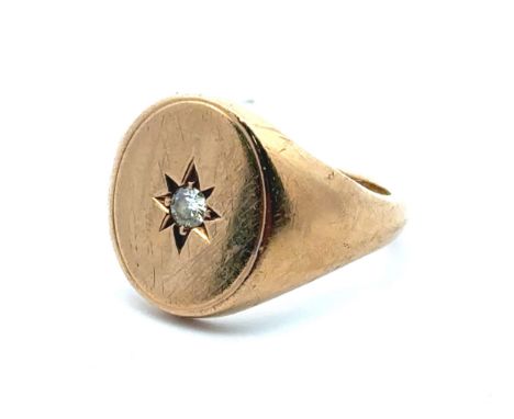A gypsy set diamond oval signet ring mounted in 9ct gold. Diamond approx 0.1ct. Size R.