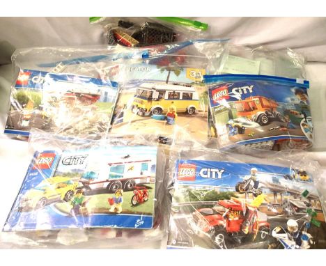 Seven Lego vehicles; car and caravan, tow truck, fire engine, campervan, garbage truck (some missing figures) and two others 