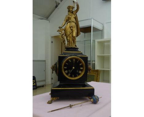 A 19th century black slate & gilt metal French mantel clock mounted with lions heads and a maiden on lion's paw feet