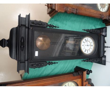 A 19th century ebonised Vienna wall clock: enamel dial with broken arch pediment
