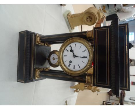 A 19th century ebonised & gilt wood French mantel clock: the clock supported on four columns