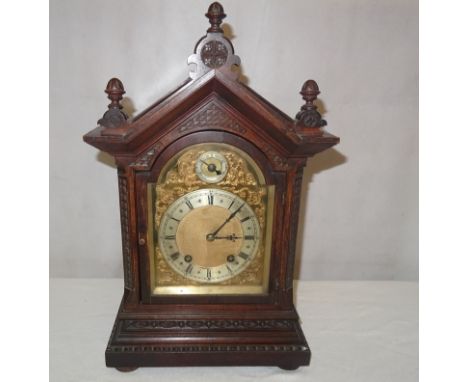 An oak-cased mantel clock
