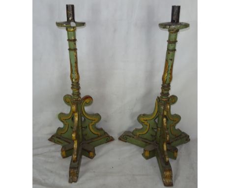 A pair of 19th century painted and gilded pine pricket candlestick holders
